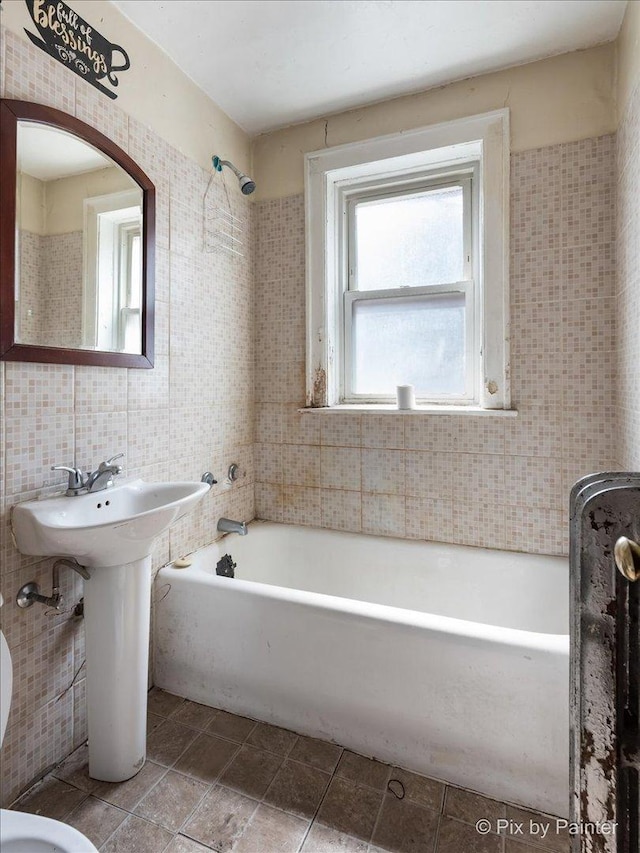 full bathroom with tile patterned flooring, tile walls, and shower / bath combination