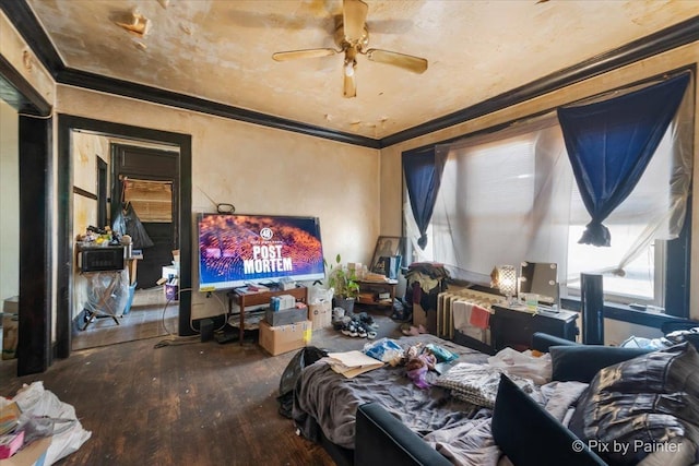 living room with hardwood / wood-style floors, ceiling fan, and crown molding