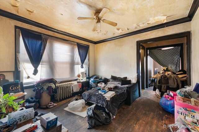 interior space with a ceiling fan, wood finished floors, and crown molding