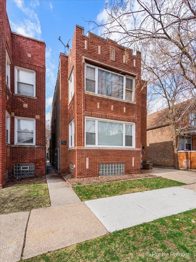 view of front of home featuring brick siding