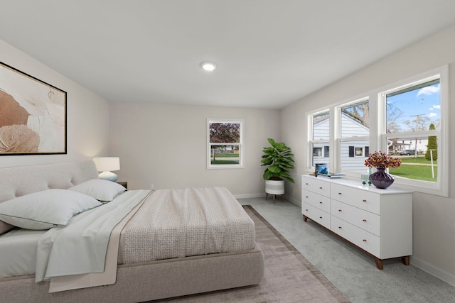 bedroom featuring baseboards and light colored carpet