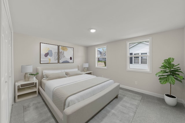 bedroom featuring baseboards and light colored carpet