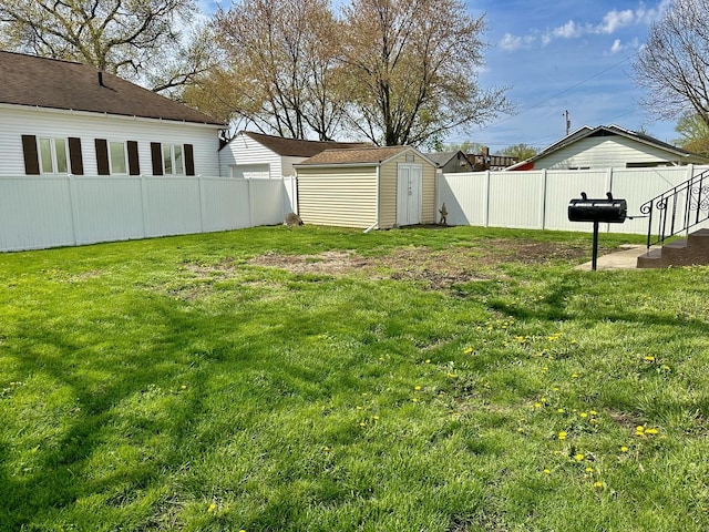 view of yard with a fenced backyard, a storage unit, and an outdoor structure