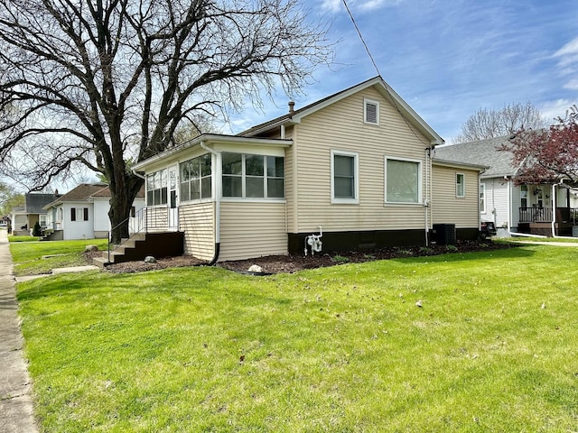 view of property exterior with cooling unit and a lawn