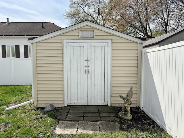 view of shed featuring fence
