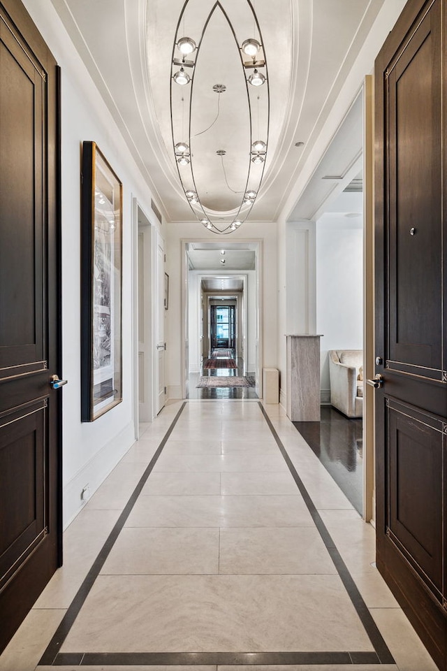 159 E Walton Pl Unit 34A, Chicago, IL 60611 - hall featuring a tray ceiling and light tile patterned flooring