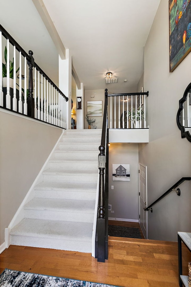 stairs featuring baseboards and wood finished floors