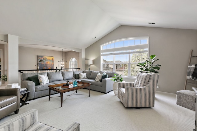 living room featuring visible vents, light carpet, and lofted ceiling