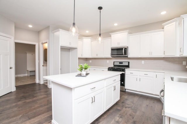 kitchen featuring light countertops, dark wood-style floors, white cabinetry, and appliances with stainless steel finishes