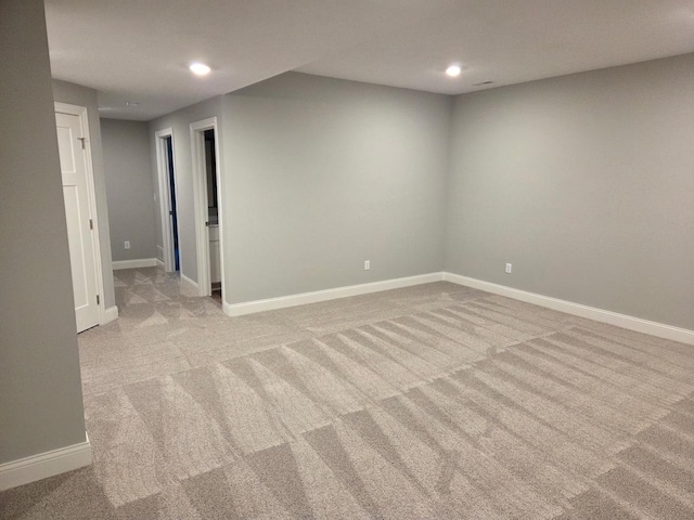 finished below grade area featuring recessed lighting, baseboards, and light colored carpet