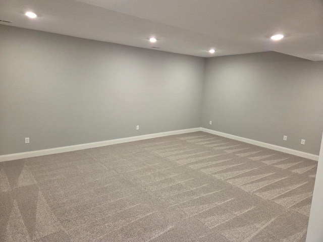 carpeted spare room featuring baseboards and recessed lighting