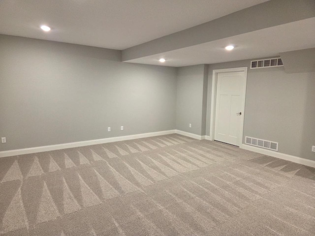 finished basement with visible vents, carpet flooring, and recessed lighting
