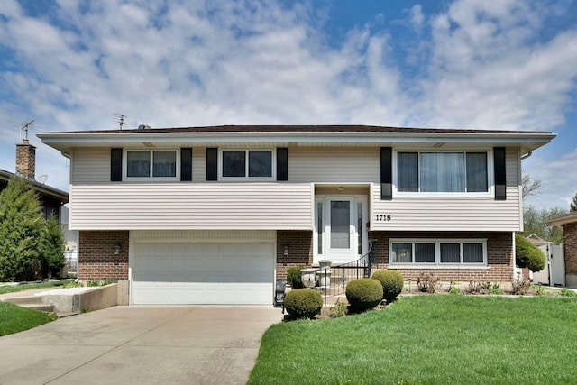 1718 W Woodland Ave, Addison, IL 60101 - bi-level home with brick siding, a front yard, and concrete driveway
