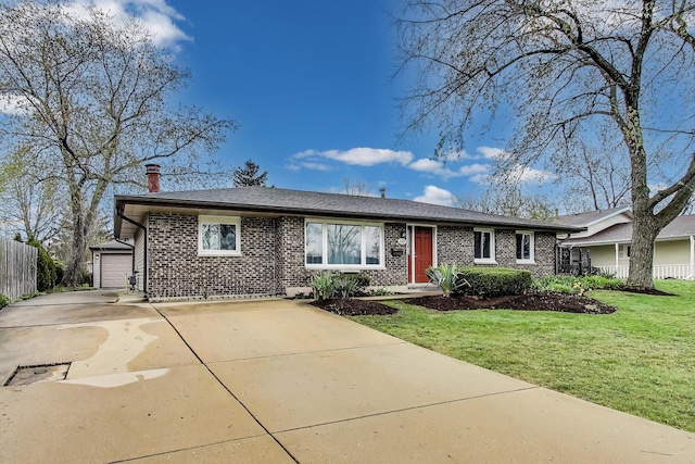 ranch-style home with a front lawn, a garage, brick siding, concrete driveway, and fence