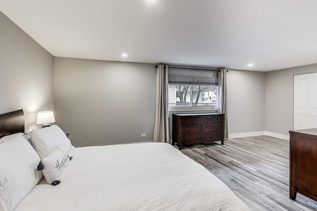 bedroom featuring baseboards, recessed lighting, and wood finished floors