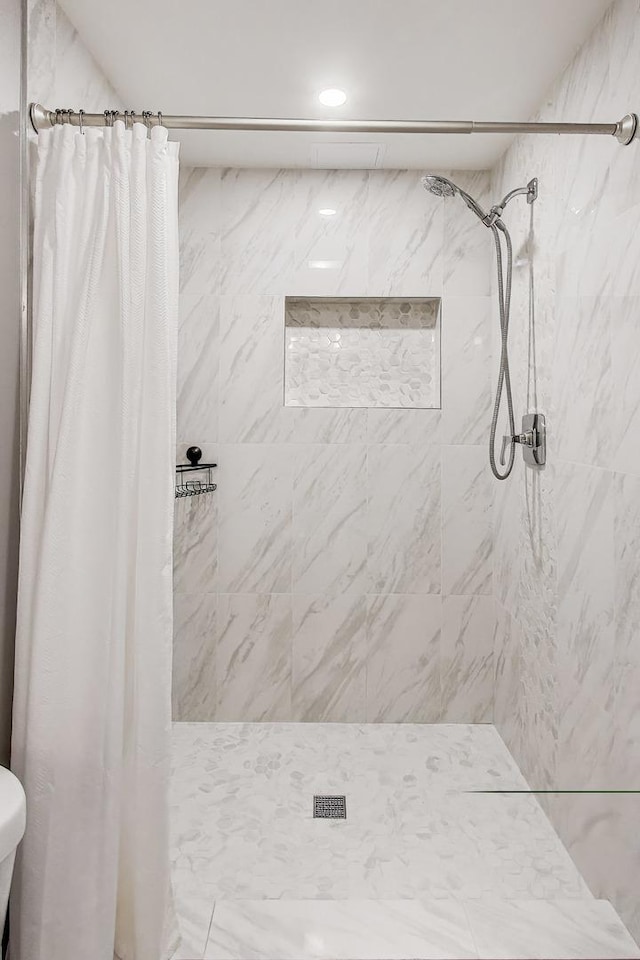 bathroom with recessed lighting and a shower stall