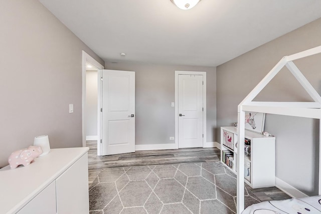 interior space with baseboards and wood finished floors