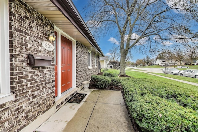 property entrance featuring brick siding