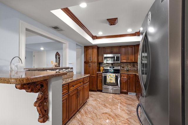 11138 Center Rd Unit E22, Palos Hills, IL 60465 - kitchen featuring appliances with stainless steel finishes, tasteful backsplash, a raised ceiling, light stone counters, and brown cabinets