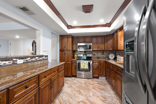 11138 Center Rd Unit E22, Palos Hills, IL 60465 - kitchen featuring stainless steel appliances, a tray ceiling, decorative backsplash, light stone countertops, and crown molding