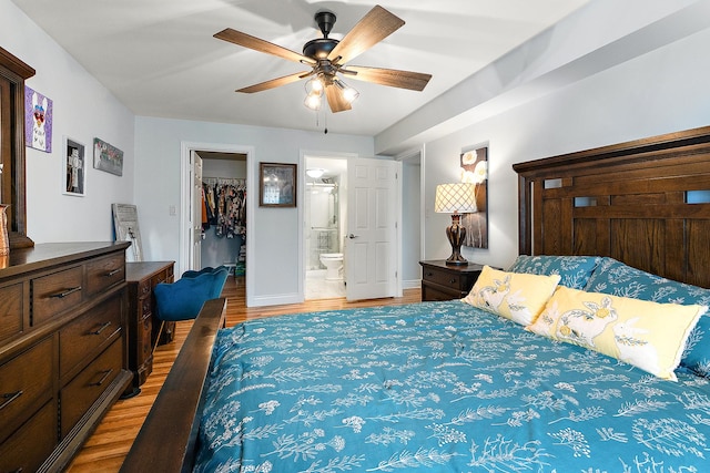 11138 Center Rd Unit E22, Palos Hills, IL 60465 - bedroom featuring light wood finished floors, a spacious closet, a closet, ceiling fan, and connected bathroom