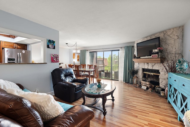 11138 Center Rd Unit E22, Palos Hills, IL 60465 - living room featuring light wood-style floors and a fireplace