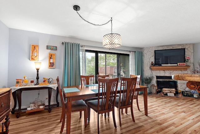 11138 Center Rd Unit E22, Palos Hills, IL 60465 - dining space featuring light wood finished floors and a stone fireplace