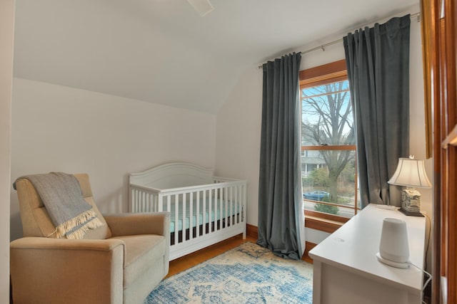 1726 Wesley Ave, Evanston, IL 60201 - bedroom featuring lofted ceiling, a crib, and wood finished floors