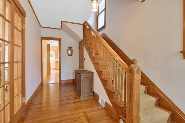 1726 Wesley Ave, Evanston, IL 60201 - stairs with wood finished floors, visible vents, baseboards, and ornamental molding