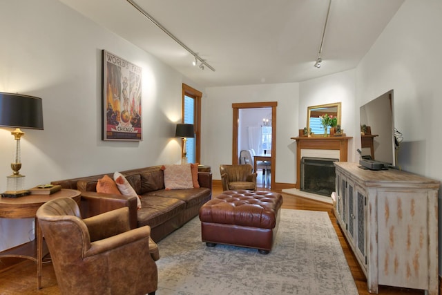 1726 Wesley Ave, Evanston, IL 60201 - living room with wood finished floors, rail lighting, and a fireplace with raised hearth