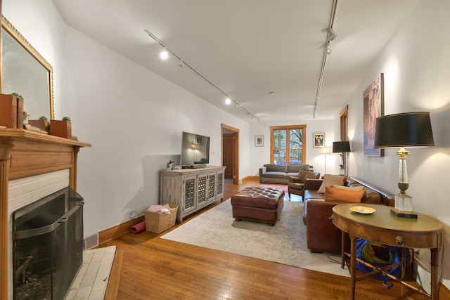 1726 Wesley Ave, Evanston, IL 60201 - living area with rail lighting, baseboards, hardwood / wood-style floors, and a fireplace
