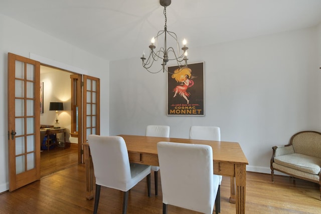 1726 Wesley Ave, Evanston, IL 60201 - dining area with baseboards, french doors, wood finished floors, and a notable chandelier