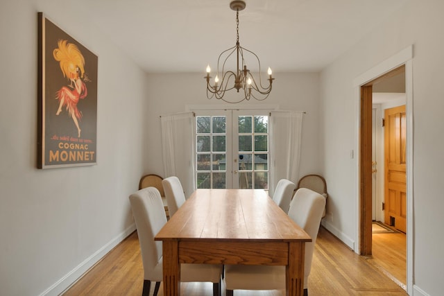1726 Wesley Ave, Evanston, IL 60201 - dining area featuring light wood-type flooring, baseboards, french doors, and an inviting chandelier