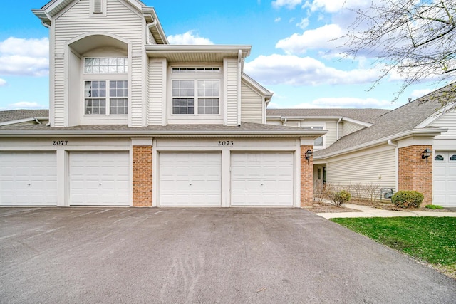 2073 Cambria Ct, Northbrook, IL 60062 - view of front of home featuring brick siding, driveway, and a garage