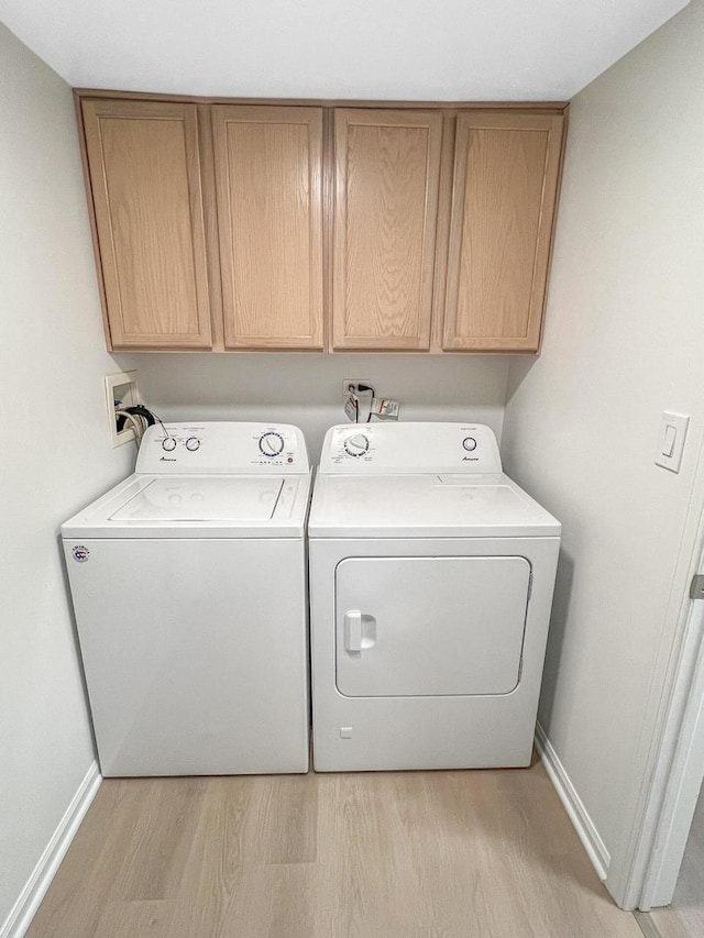 2073 Cambria Ct, Northbrook, IL 60062 - washroom featuring cabinet space, light wood-style flooring, baseboards, and washer and clothes dryer