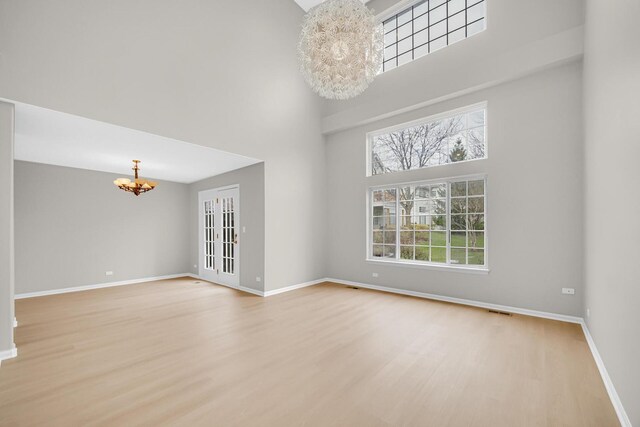 2073 Cambria Ct, Northbrook, IL 60062 - empty room with wood finished floors, a towering ceiling, and a chandelier