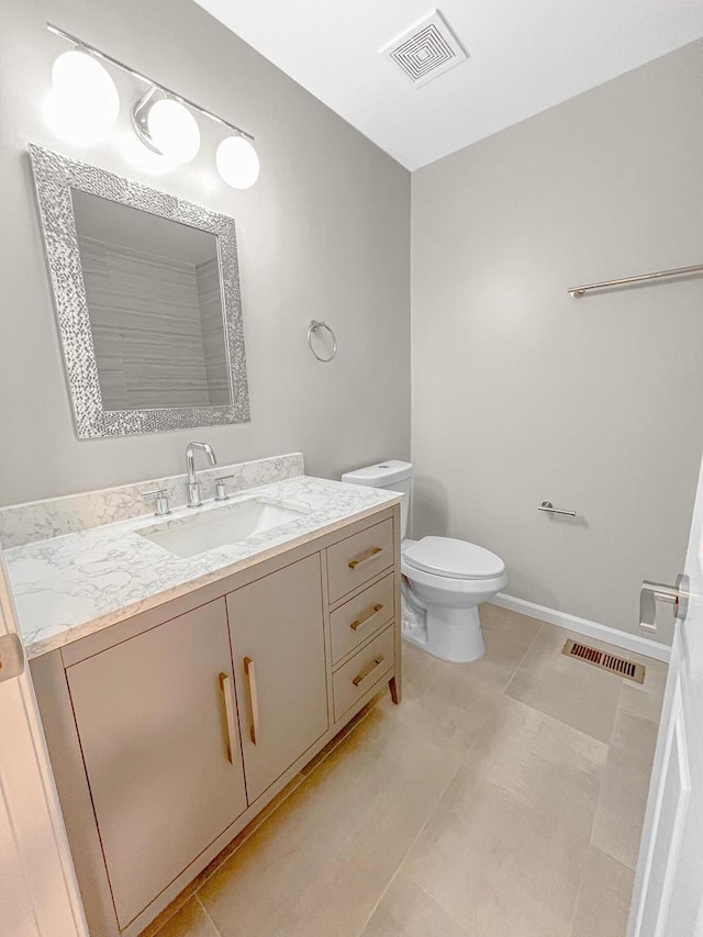 2073 Cambria Ct, Northbrook, IL 60062 - bathroom with toilet, vanity, visible vents, and baseboards
