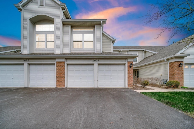 2073 Cambria Ct, Northbrook, IL 60062 - view of front of home with brick siding, a garage, and aphalt driveway