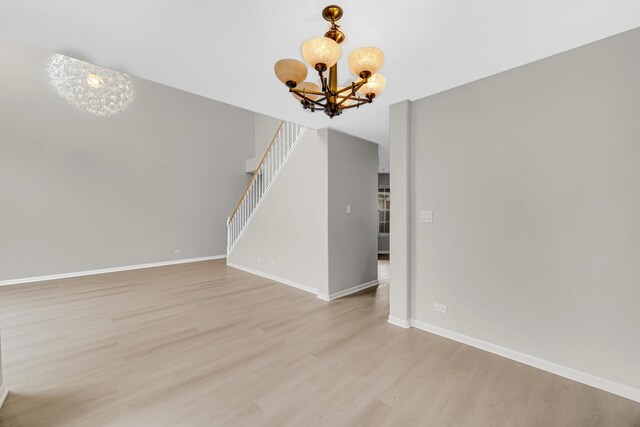 2073 Cambria Ct, Northbrook, IL 60062 - interior space with baseboards, an inviting chandelier, light wood-style floors, and stairway