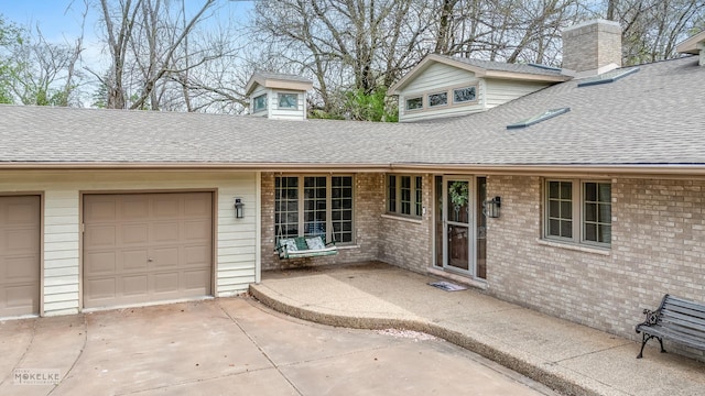 7S745 State Route 53rd Hwy, Naperville, IL 60540 - view of front of home with roof with shingles, a chimney, concrete driveway, a garage, and brick siding