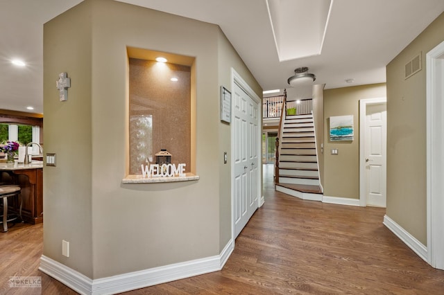7S745 State Route 53rd Hwy, Naperville, IL 60540 - hallway featuring wood finished floors, baseboards, stairway, and a sink