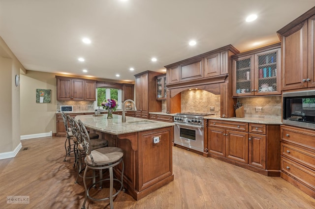 7S745 State Route 53rd Hwy, Naperville, IL 60540 - kitchen featuring a sink, high end stainless steel range oven, baseboards, light stone countertops, and built in microwave