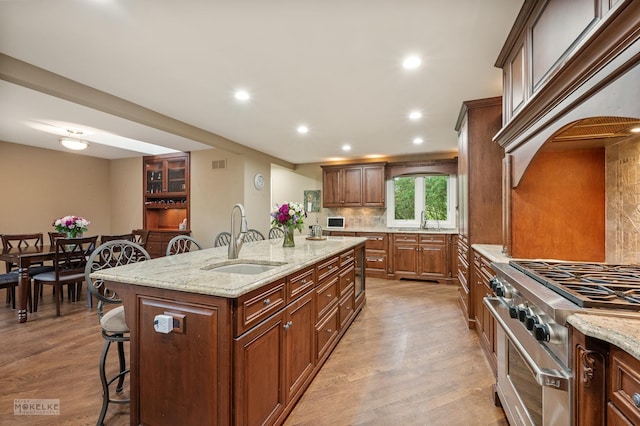7S745 State Route 53rd Hwy, Naperville, IL 60540 - kitchen with a sink, a kitchen bar, high end stove, light wood-style flooring, and recessed lighting