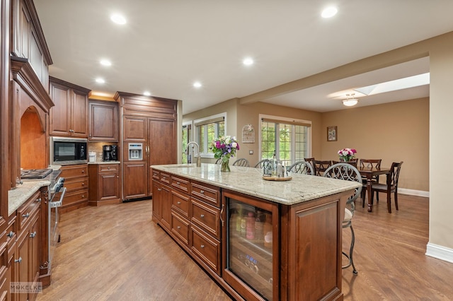 7S745 State Route 53rd Hwy, Naperville, IL 60540 - kitchen featuring a kitchen breakfast bar, beverage cooler, a sink, built in appliances, and baseboards