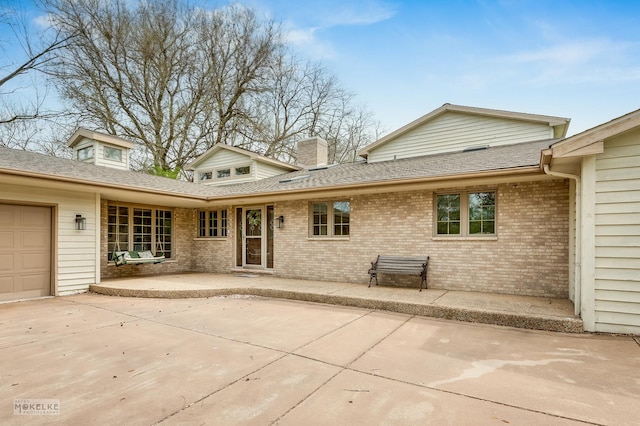 7S745 State Route 53rd Hwy, Naperville, IL 60540 - rear view of property with brick siding, an attached garage, roof with shingles, a chimney, and a patio