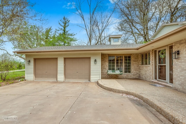 7S745 State Route 53rd Hwy, Naperville, IL 60540 - view of front of house featuring a garage, concrete driveway, and brick siding