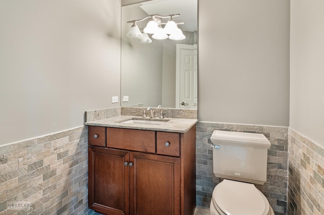 7S745 State Route 53rd Hwy, Naperville, IL 60540 - bathroom with tile walls, wainscoting, toilet, vanity, and a chandelier