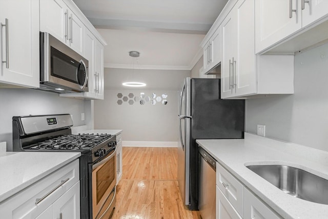 5415 S Dorchester Ave Unit 2B, Chicago, IL 60615 - kitchen with stainless steel appliances, white cabinets, light wood-style flooring, hanging light fixtures, and light stone countertops