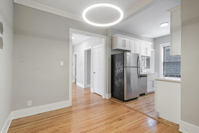 5415 S Dorchester Ave Unit 2B, Chicago, IL 60615 - kitchen featuring stainless steel appliances, light wood-type flooring, light countertops, a sink, and white cabinetry