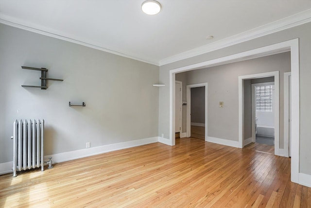 5415 S Dorchester Ave Unit 2B, Chicago, IL 60615 - spare room with radiator heating unit, ornamental molding, light wood finished floors, and baseboards